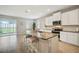 Modern kitchen with granite island, stainless steel appliances, and view of backyard at 5282 Grove Mill Loop, Bradenton, FL 34211