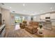 Spacious living room with access to backyard, tile floors, and comfortable seating at 5282 Grove Mill Loop, Bradenton, FL 34211