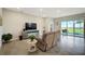 Relaxing living room with large TV, sliding glass doors, and tile flooring at 5282 Grove Mill Loop, Bradenton, FL 34211