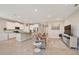 Open concept living room features kitchen island, stainless steel appliances, and tile flooring at 5282 Grove Mill Loop, Bradenton, FL 34211