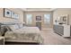 Spacious main bedroom with carpeted floor, window shutters, and large dresser at 5282 Grove Mill Loop, Bradenton, FL 34211