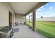 Covered patio with a grill and comfortable seating at 5282 Grove Mill Loop, Bradenton, FL 34211