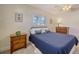 Simple bedroom with a double bed and wood nightstand at 5308 Coral Blvd, Bradenton, FL 34210