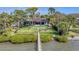 Aerial view showcasing home, dock and lush landscaping at 603 Harbor Shore Dr, Nokomis, FL 34275