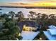 Aerial view of waterfront home at sunset at 603 Harbor Shore Dr, Nokomis, FL 34275