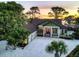 Aerial sunset view of the house and surrounding area at 603 Harbor Shore Dr, Nokomis, FL 34275