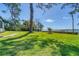 Expansive grassy backyard with a waterfront view at 603 Harbor Shore Dr, Nokomis, FL 34275