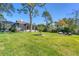 Landscaped backyard featuring a home with a screened porch at 603 Harbor Shore Dr, Nokomis, FL 34275