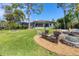 Relaxing patio with fire pit and seating area near the home at 603 Harbor Shore Dr, Nokomis, FL 34275