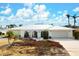 Single-story home exterior, featuring a light-colored facade and landscaping at 606 Gladstone Ln, Holmes Beach, FL 34217