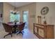 Bright breakfast nook with wicker chairs and a glass table, overlooking a lush patio at 644 Rivendell Blvd, Osprey, FL 34229