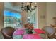 Breakfast nook features a glass table, wicker chairs, and a view of the backyard at 644 Rivendell Blvd, Osprey, FL 34229