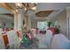 Elegant dining room, featuring a glass top table, and adjacent living room at 644 Rivendell Blvd, Osprey, FL 34229