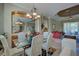 Open dining room with a glass table and view into living room at 644 Rivendell Blvd, Osprey, FL 34229