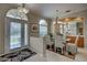 Bright dining room featuring a glass table, neutral colors, and arched windows at 644 Rivendell Blvd, Osprey, FL 34229
