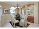 Bright dining room with glass table, chandelier, and built-in cabinetry at 644 Rivendell Blvd, Osprey, FL 34229