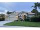 Beige house with three-car garage and manicured lawn at 644 Rivendell Blvd, Osprey, FL 34229