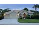 Beige house with three-car garage and manicured lawn at 644 Rivendell Blvd, Osprey, FL 34229