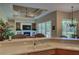 Kitchen features a breakfast bar overlooking living room and fireplace at 644 Rivendell Blvd, Osprey, FL 34229