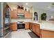 Well-equipped kitchen with stainless steel appliances and wood cabinets at 644 Rivendell Blvd, Osprey, FL 34229
