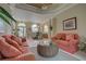 Comfortable living room, coral striped sofas, wicker coffee table, view of dining area at 644 Rivendell Blvd, Osprey, FL 34229