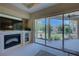 Living area features a fireplace, large TV, and sliding glass doors to the patio at 644 Rivendell Blvd, Osprey, FL 34229