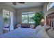 Spacious main bedroom with king-size bed and access to a private patio at 644 Rivendell Blvd, Osprey, FL 34229