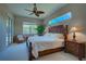 Main bedroom with king-size bed, ceiling fan, and access to the patio at 644 Rivendell Blvd, Osprey, FL 34229