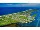 Aerial view of coastal community with waterfront homes and lush landscaping at 653 Cedars Ct, Longboat Key, FL 34228