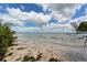 Stunning view of calm ocean waters from a peaceful beach at 653 Cedars Ct, Longboat Key, FL 34228