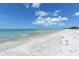 Expansive beachfront view of serene ocean waters and a beautiful sandy shoreline at 653 Cedars Ct, Longboat Key, FL 34228
