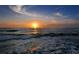 Breathtaking sunset over the ocean with vibrant colors and tranquil waves at 653 Cedars Ct, Longboat Key, FL 34228