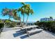 Relaxing picnic area with table and benches, overlooking the calm waters at 653 Cedars Ct, Longboat Key, FL 34228