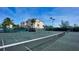 Tennis court with building in background at 653 Cedars Ct, Longboat Key, FL 34228