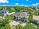Aerial view of modern home, tropical landscaping, and waterfront location at 6530 Peacock Rd, Sarasota, FL 34242