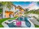Inviting pool and patio area with water features, at sunset at 6530 Peacock Rd, Sarasota, FL 34242