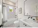 Clean bathroom with a tub, shower, and patterned tile at 6530 Peacock Rd, Sarasota, FL 34242