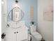 Modern powder room with a white vanity and patterned floor tiles at 6530 Peacock Rd, Sarasota, FL 34242