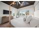 Main bedroom with a four-poster bed and dark wood ceiling at 6530 Peacock Rd, Sarasota, FL 34242
