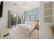 Spacious bedroom with a queen-size bed and access to a balcony at 6530 Peacock Rd, Sarasota, FL 34242