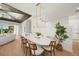 Elegant dining area with a white oval table and modern light fixture at 6530 Peacock Rd, Sarasota, FL 34242