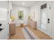 Bright and airy entryway with light wood cabinets and flooring at 6530 Peacock Rd, Sarasota, FL 34242
