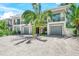Contemporary two-story home with attached garage and landscaping at 6530 Peacock Rd, Sarasota, FL 34242