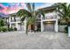 Two story home with attached garage, under sunset at 6530 Peacock Rd, Sarasota, FL 34242