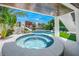 Circular hot tub on a patio, overlooking the pool and waterway at 6530 Peacock Rd, Sarasota, FL 34242