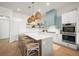 Modern kitchen with a large island, white cabinets, and light wood floors at 6530 Peacock Rd, Sarasota, FL 34242