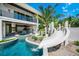 Modern pool and waterslide in a tropical setting at 6530 Peacock Rd, Sarasota, FL 34242