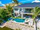 Luxury pool with a slide, spa, and outdoor entertaining space at 6530 Peacock Rd, Sarasota, FL 34242