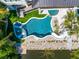 Elevated view of modern freeform pool with slide and spa at 6530 Peacock Rd, Sarasota, FL 34242