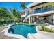 Luxury pool with a slide, spa, and lounge chairs; perfect for entertaining at 6530 Peacock Rd, Sarasota, FL 34242